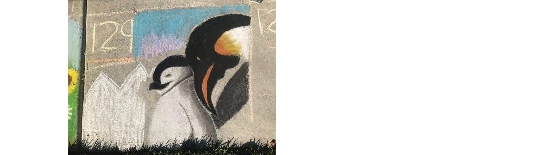 large penguin standing next to child penguin