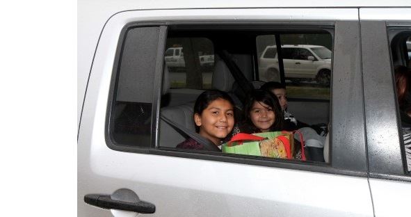 children smiling in car